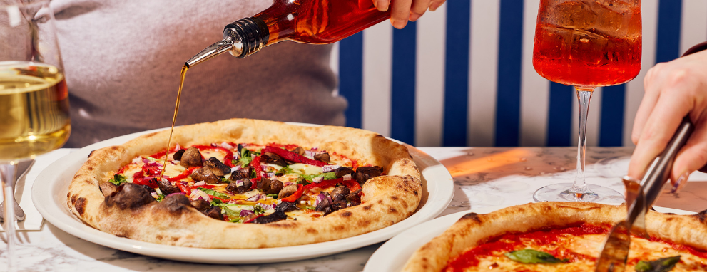 Someone eating pasta and a salad at Prezzo